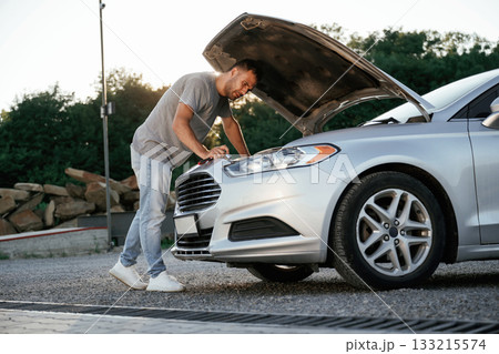 Problem, fixing and repairing the broken automobile. Man is with his car outdoors 133215574