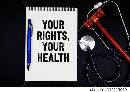 Notepad with "Your Rights, Your Health" a pen, gavel, and stethoscope on a black background Notepad with "Your Rights, Your Health" a pen, gavel, and stethoscope on a black background 133215650