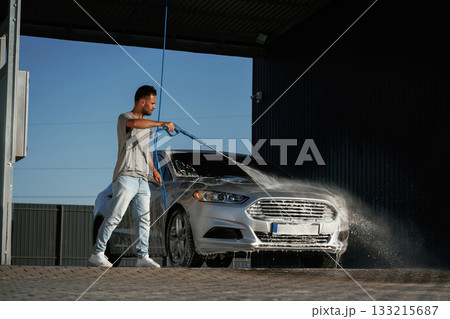 Water high pressure stream, car wash. Man is...の写真素材 [133215687] - PIXTA
