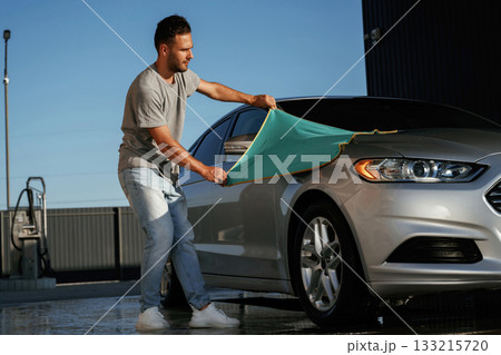 Cloth, cleaning the automobile. Man is with his car outdoors Cloth, cleaning the automobile. Man is with his car outdoors 133215720