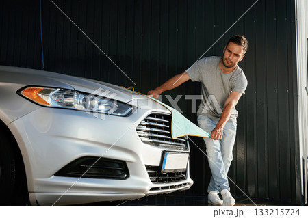 Cloth, cleaning the automobile. Man is with his car outdoors 133215724