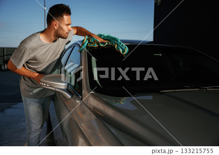 Working, polishing the automobile. Man is with his car outdoors 133215755