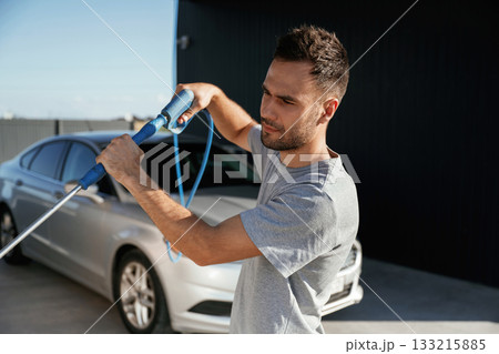 Ready to wash the automobile. Man is with his car outdoors 133215885