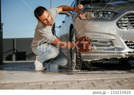 Process of polishing to perfection. Man is with his car outdoors 133215919