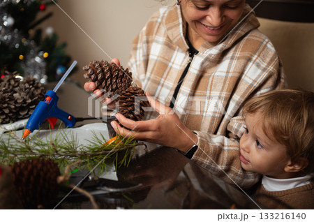 Family Christmas Crafting With Pinecones And Glue Gun At Home Family Christmas Crafting With Pinecones And Glue Gun At Home 133216140