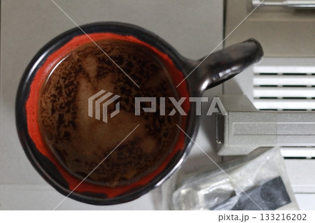 A mysterious silhouette on the surface of the coffee. A mysterious silhouette on the surface of the coffee. 133216202
