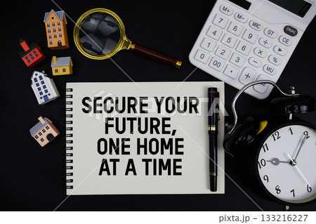 Notepad with the phrase "Secure Your Future, One Home At A Time" surrounded by a pen, calculator, magnifying glass, clock, and house model 133216227