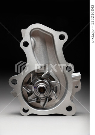 Engine cooling pump, engine coolant pump for a passenger car on a black gradient background. Selective focus Engine cooling pump, engine coolant pump for a passenger car on a black gradient background. Selective focus 133216842