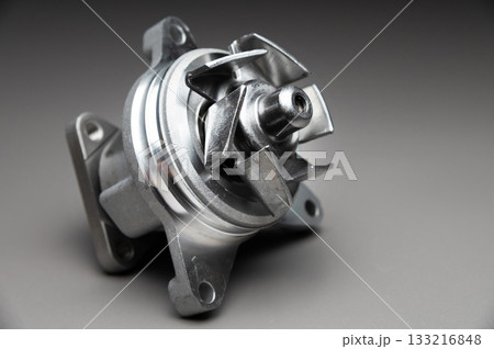 Engine cooling pump, engine coolant pump for a passenger car on a black gradient background. Selective focus Engine cooling pump, engine coolant pump for a passenger car on a black gradient background. Selective focus 133216848