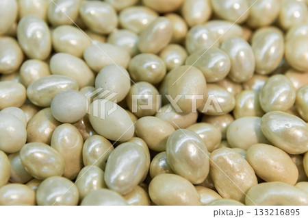 Close-up of brown dragee, chocolate covered nuts, sweet candy background. 133216895