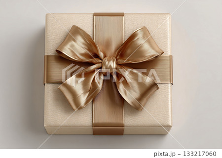 Holiday packaging. Gold box wrapped with a bow on white background. Jewelry, birthdays, Christmas and luxury branding. Holiday packaging. Gold box wrapped with a bow on white background. Jewelry, birthdays, Christmas and luxury branding. 133217060