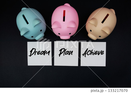 Piggy bank with text "Dream, Plan and Achieve" on black background Piggy bank with text "Dream, Plan and Achieve" on black background 133217070