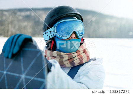 Portrait Of Woman Holding a Snowboard And Wearing Ski Glasses Portrait Of Woman Holding a Snowboard And Wearing Ski Glasses 133217272