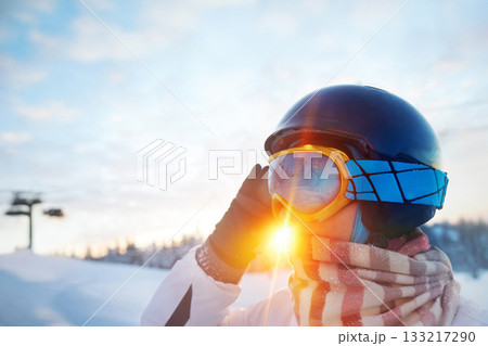 Woman At The Ski Resort On The Background Of Mountains And Blue Sky.A Mountain Range Reflected In The Ski Mask. Winter Sports. 133217290