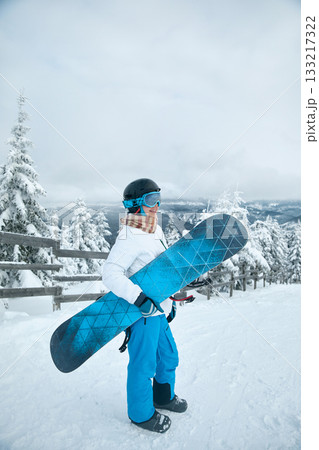 Winter Sports. Portrait Of Woman On The Background Of Mountains. A mountain range reflected in the ski mask. Winter Sports. Portrait Of Woman On The Background Of Mountains. A mountain range reflected in the ski mask. 133217322