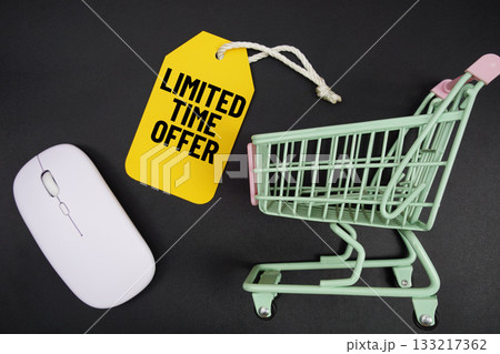 Mini Trolley Shopping Cart and price tag with message "Limited Time Offer" and wireless mouse on black background 133217362