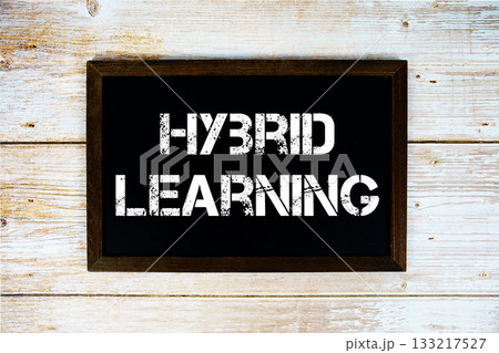 Hybrid Learning text with gift box present and alarm clock on black background 133217527