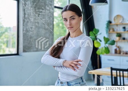 Portrait of confident successful teenage girl posing with crossed arms at home 133217625