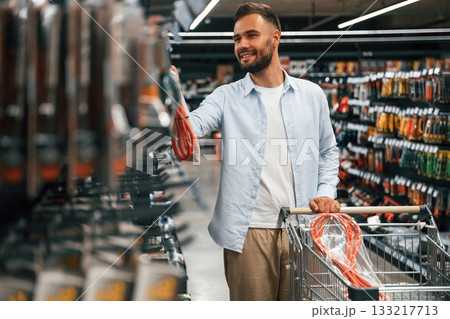 Goods, bunch of tools. Man is in the hardware shop Goods, bunch of tools. Man is in the hardware shop 133217713