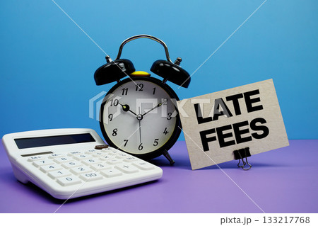 Late Fees text with calculator and alarm clock on blue and purple background 133217768