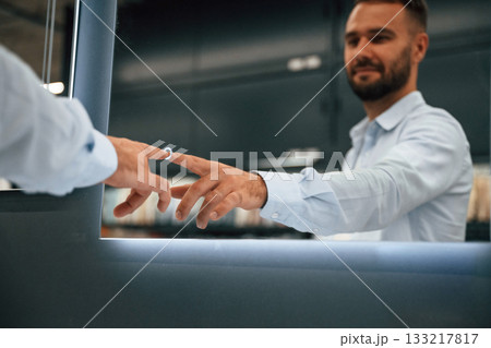 Touching, trying smart mirror. Man is in the hardware shop 133217817