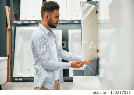 Bathroom goods. Man is in the hardware shop Bathroom goods. Man is in the hardware shop 133217818