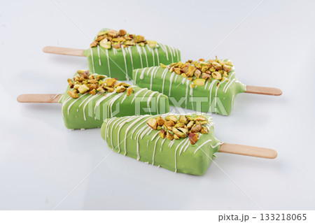 Green color. Cheesecake that looks like ice cream. Against white background 133218065