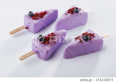 With blueberries. Cheesecake that looks like ice cream. Against white background 133218073