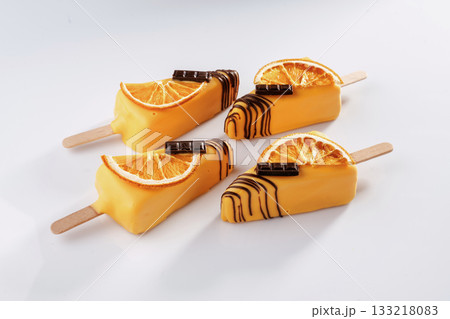 Orange fruit and chocolate. Cheesecake that looks like ice cream. Against white background 133218083