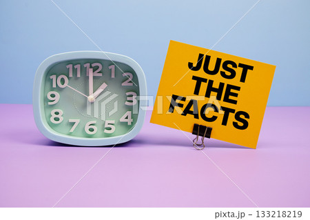 Just The Facts text and alarm clock on blue and purple background Just The Facts text and alarm clock on blue and purple background 133218219