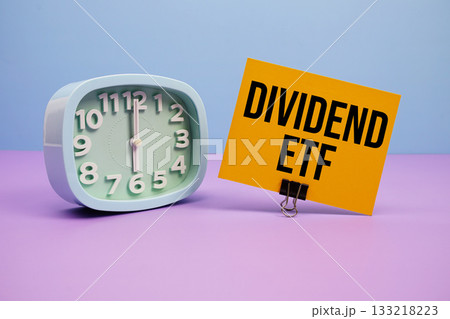 Dividend ETF text and alarm clock on blue and purple background Dividend ETF text and alarm clock on blue and purple background 133218223