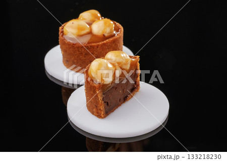 Front view, close up. Delicious cake against black background Front view, close up. Delicious cake against black background 133218230