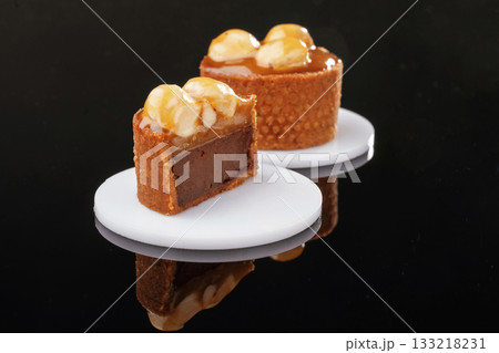 Front view, close up. Delicious cake against black background 133218231