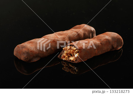 Close up view. Crispy and sweet chocolate bars on black background 133218273