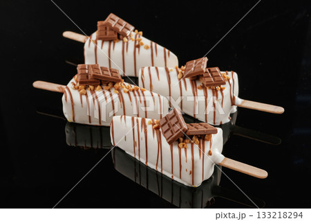 In the form of ice cream. Tasty cheesecakes on the black background In the form of ice cream. Tasty cheesecakes on the black background 133218294