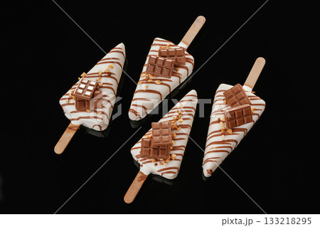 In the form of ice cream. Tasty cheesecakes on the black background In the form of ice cream. Tasty cheesecakes on the black background 133218295