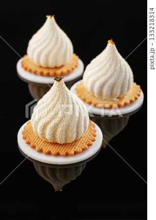 White cream. Delicious cake against black background White cream. Delicious cake against black background 133218314