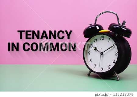 Black alarm clock on a pastel green and pink background with the text "Tenancy In Common" 133218379