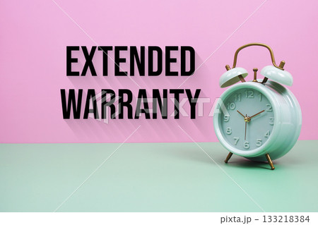Black alarm clock on a pastel green and pink background with the text "Extended Warranty" 133218384