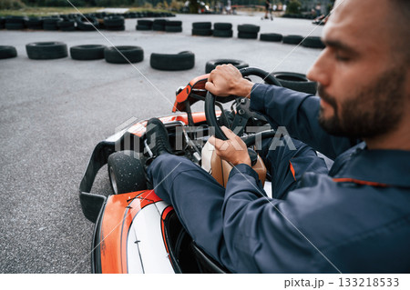 Parked, driving out. Man is outdoors, kart racing conception 133218533