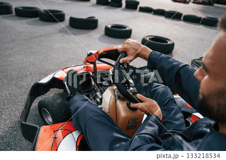 Parked, driving out. Man is outdoors, kart racing conception 133218534