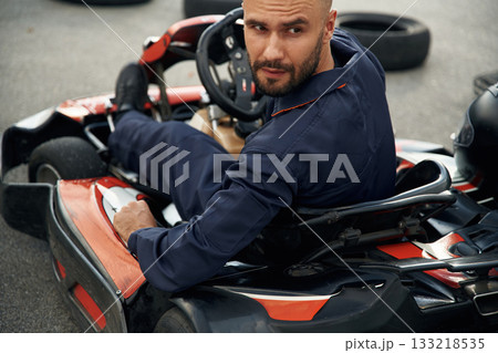 Extreme sports, driving. Man is outdoors, kart racing conception 133218535