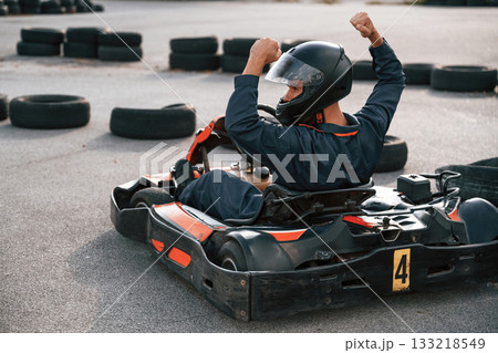 Celebrating victory. Man is outdoors, kart racing conception 133218549