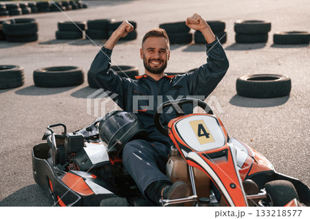 Celebrating victory. Man is outdoors, kart racing conception 133218577