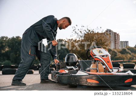 Starting the vehicle. Man is outdoors, kart racing conception Starting the vehicle. Man is outdoors, kart racing conception 133218604