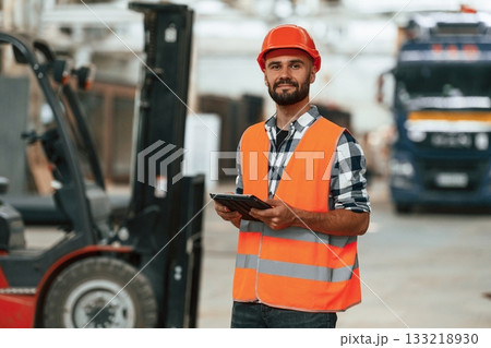 Manager is with digital tablet. Industrial worker in wooden warehouse Manager is with digital tablet. Industrial worker in wooden warehouse 133218930