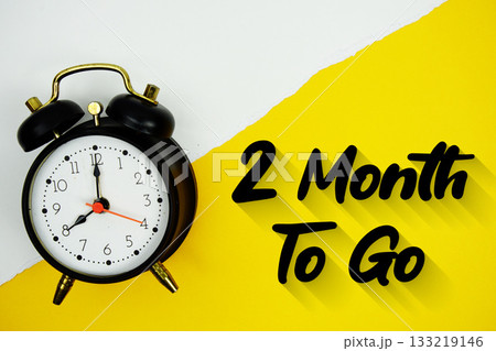2 Month To Go text and alarm clock on yellow background 133219146