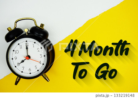 4 Month To Go text and alarm clock on yellow background 4 Month To Go text and alarm clock on yellow background 133219148