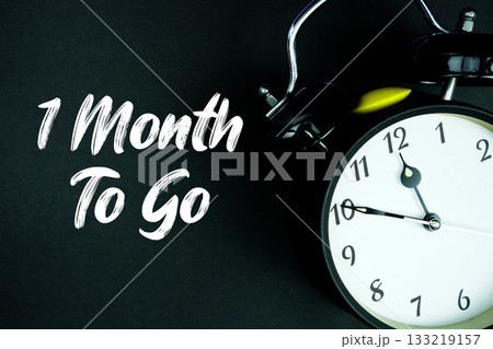 1 Month To Go text and alarm clock on black background 1 Month To Go text and alarm clock on black background 133219157