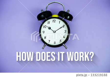 How Does It Work? text and alarm clock on purple background 133219188